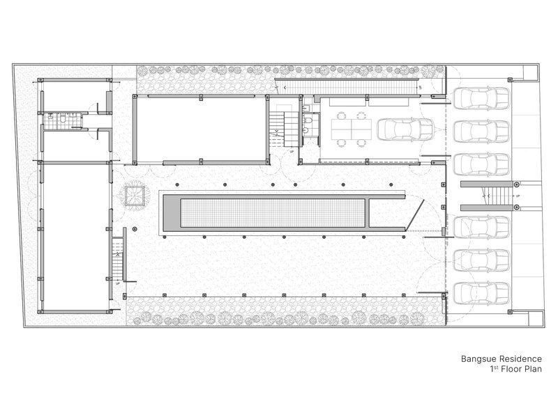 First floor plan drawing showing a central swimming pool flanked by interior rooms and parking spaces