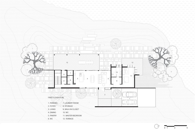 First floor plan drawing showing open living and dining spaces with terraces and surrounding trees