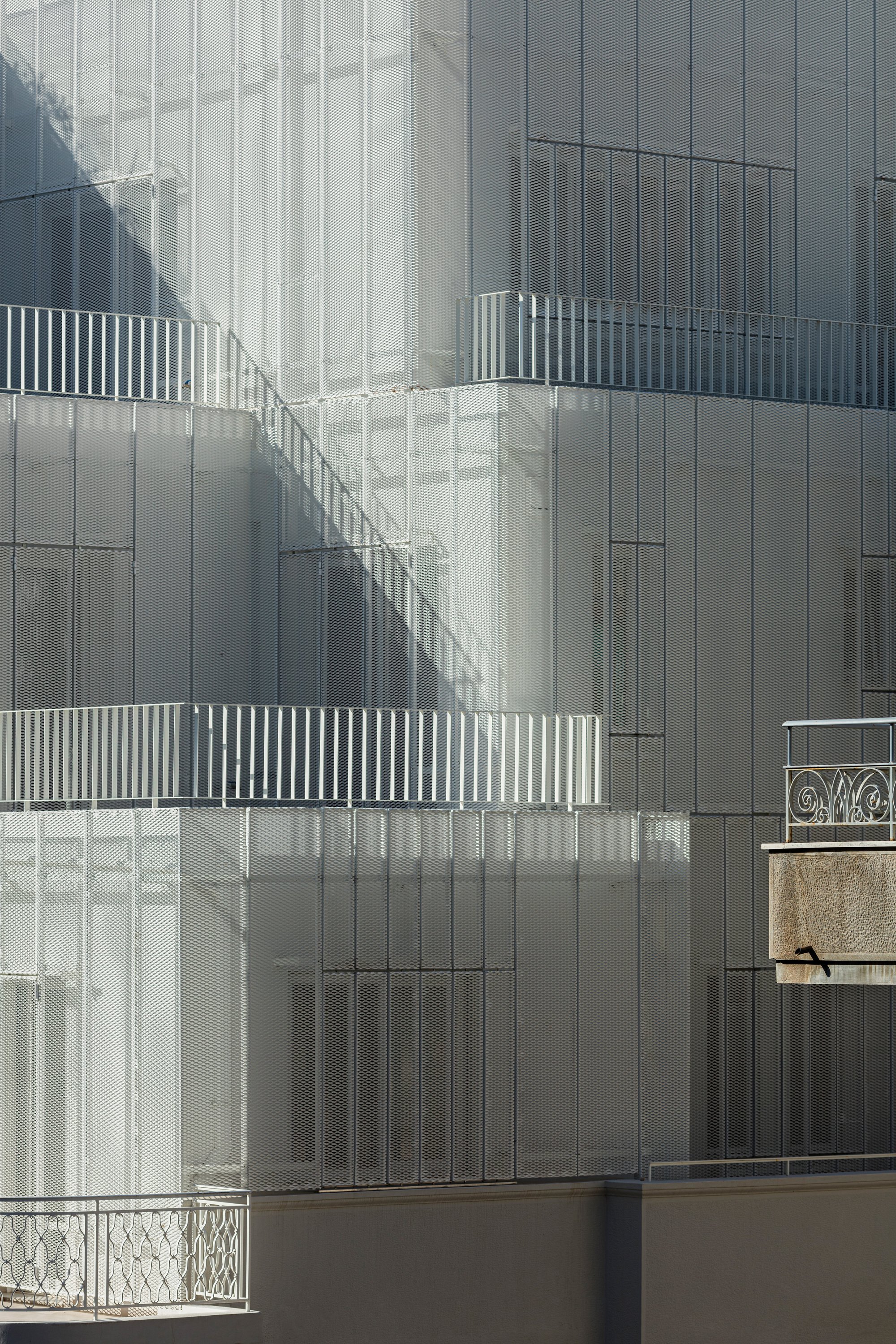 Arid Wraps a 1951 Athens Corner Building in a Perforated Aluminum Veil That Breathes