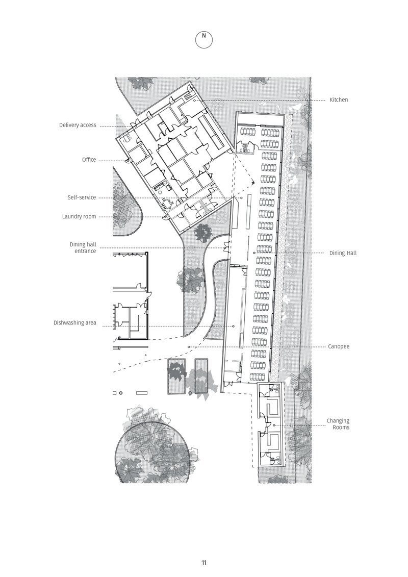 Site plan drawing showing a main building with labeled service areas alongside a long canopied parking structure