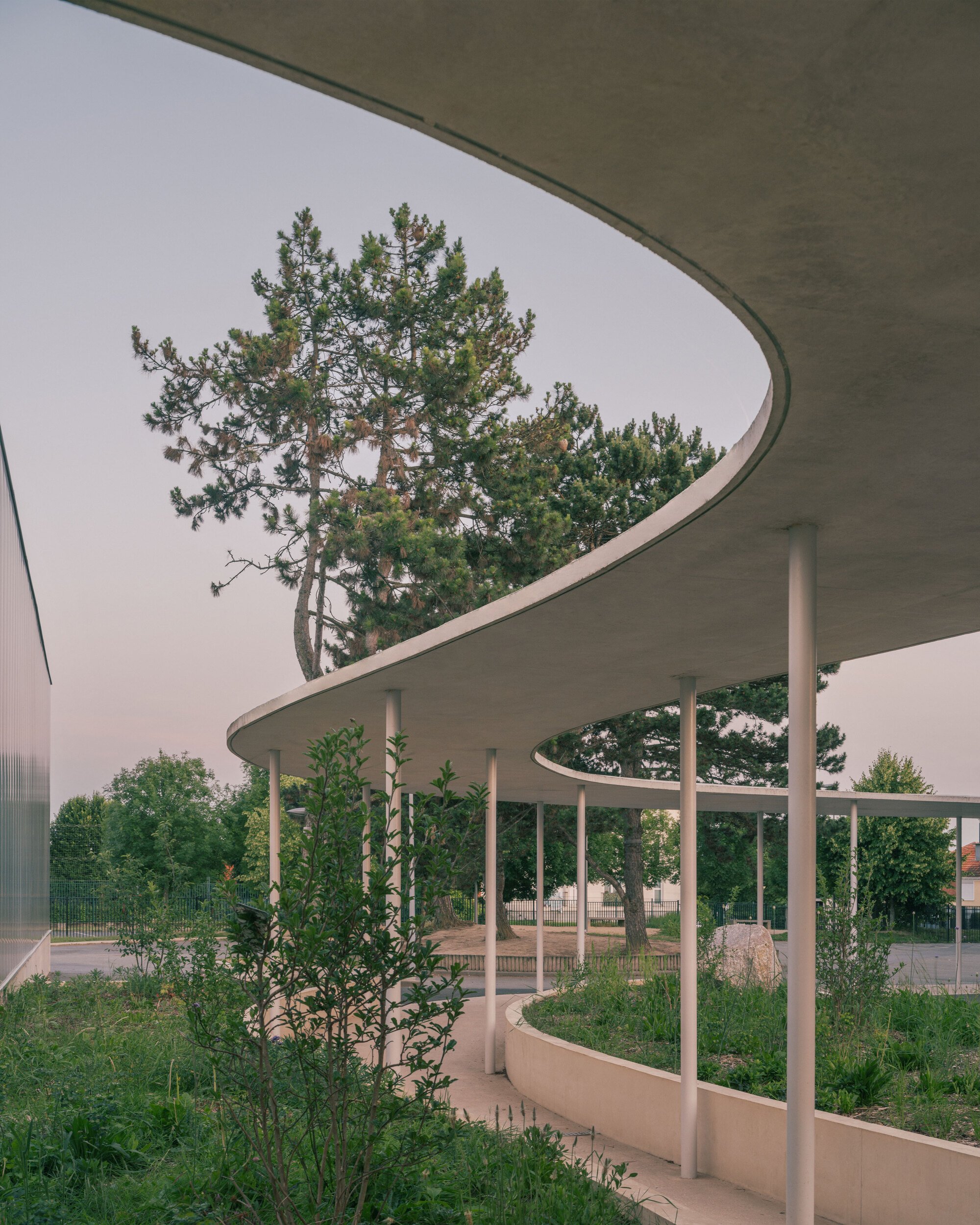 MARS Architectes Wraps a Gonesse School Cafeteria in a Curving Canopy That Shelters Trees and Children Alike