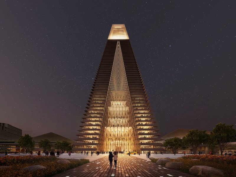 Illuminated tower entrance with triangular cutout and stacked floor plates visible under a starry night sky