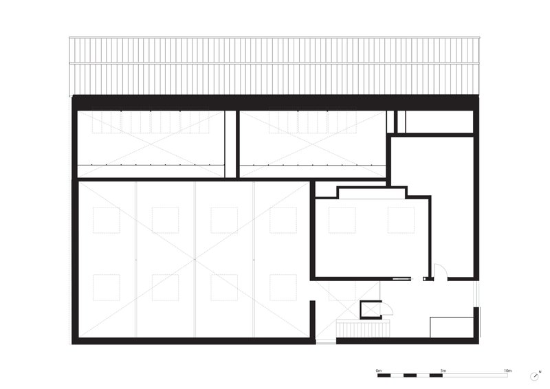 Section drawing showing gallery volumes beneath a corrugated roof structure with clerestory windows