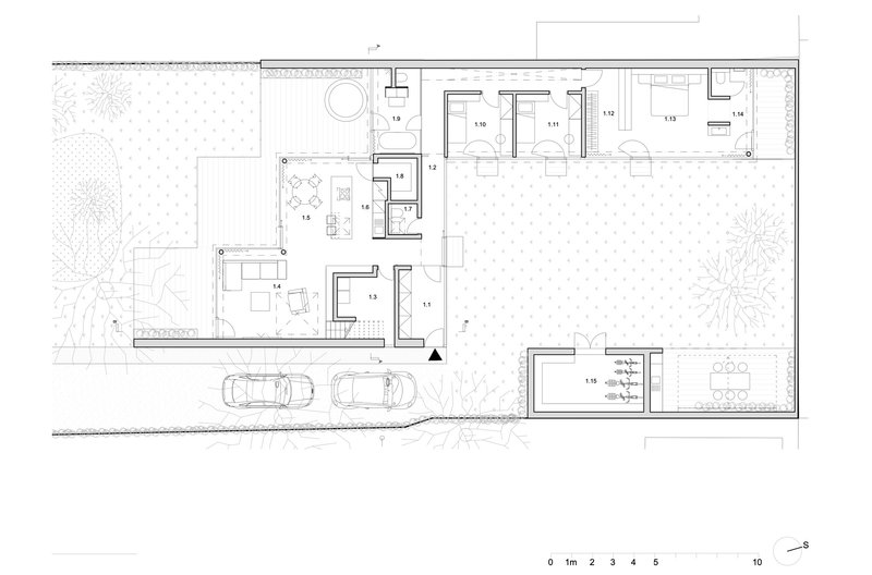 Ground floor plan drawing showing residential layout with interior courtyards and carport