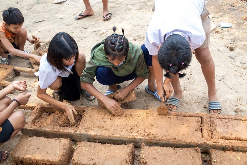 &nbsp; Students actively participate in making mud blocks using simple, local techniques.