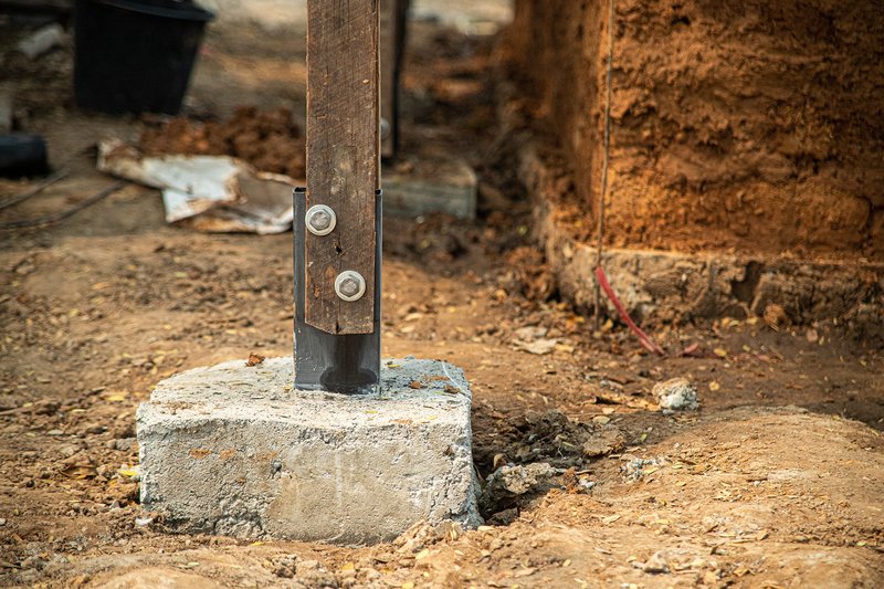 &nbsp; Steel-to-concrete footing detail ensuring stability for the timber structural frame.