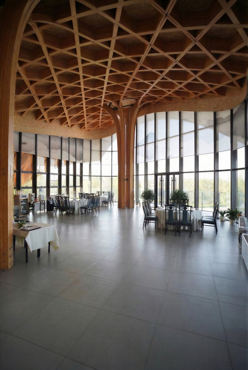 Interior dining space with timber lattice ceiling, branching wooden columns, and curtain wall overlooking landscape