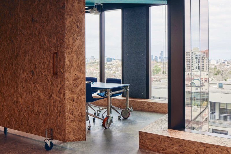 Mobile partition wall on casters beside floor-to-ceiling windows overlooking the cityscape