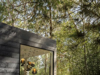 Natan Gil Arquitetura Builds a Charred Timber Hotel Room as a Desert Oasis in Belo Horizonte's Forest