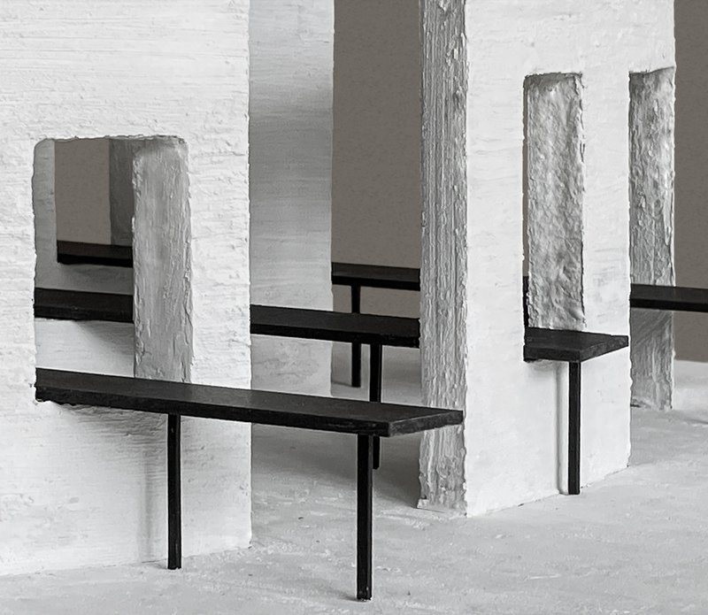 Close-up of model detail with rough-edged white panels intersecting black horizontal beams