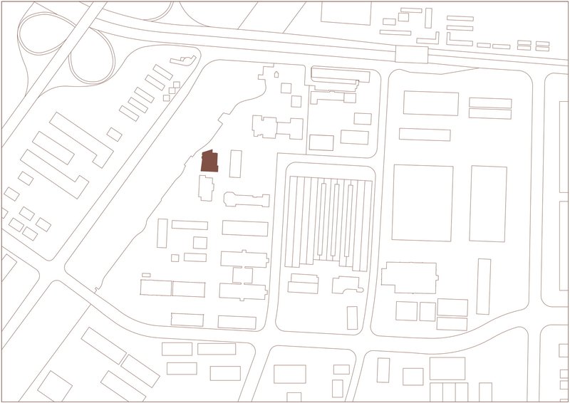 Site plan drawing highlighting a single building footprint in red within surrounding urban context
