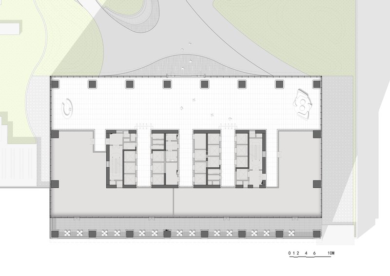 Floor plan drawing showing rectangular layout with central core and perimeter columns along landscaped edges