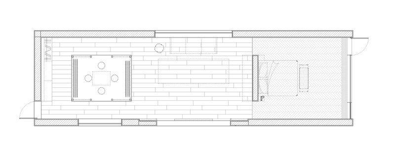 Floor plan drawing showing a long rectangular layout with kitchen, dining area and bedroom spaces