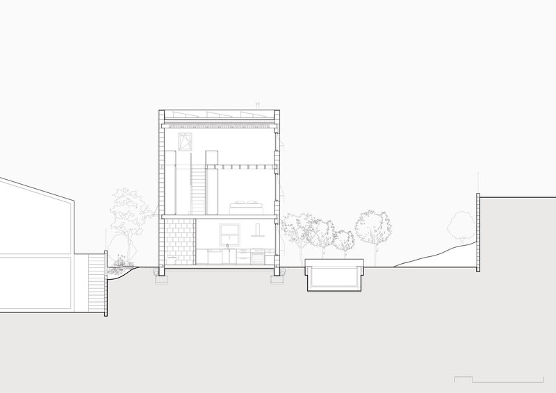 Section drawing revealing interior spaces with central staircase and surrounding landscape with trees