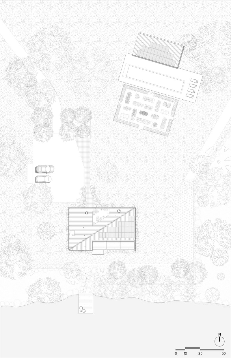 Site plan drawing depicting building footprints, parking area, pier, and surrounding tree canopy