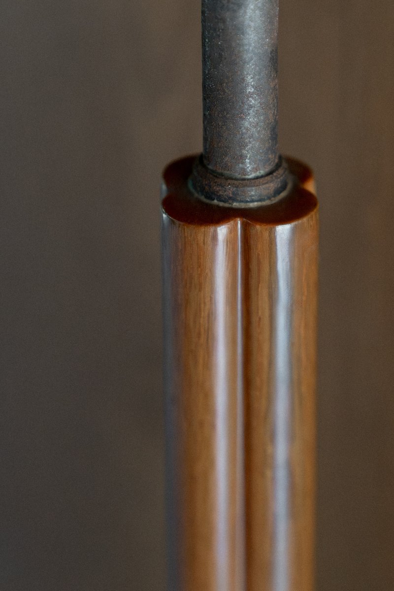 Close-up of steel pipe passing through timber sleeve with leather washer detail