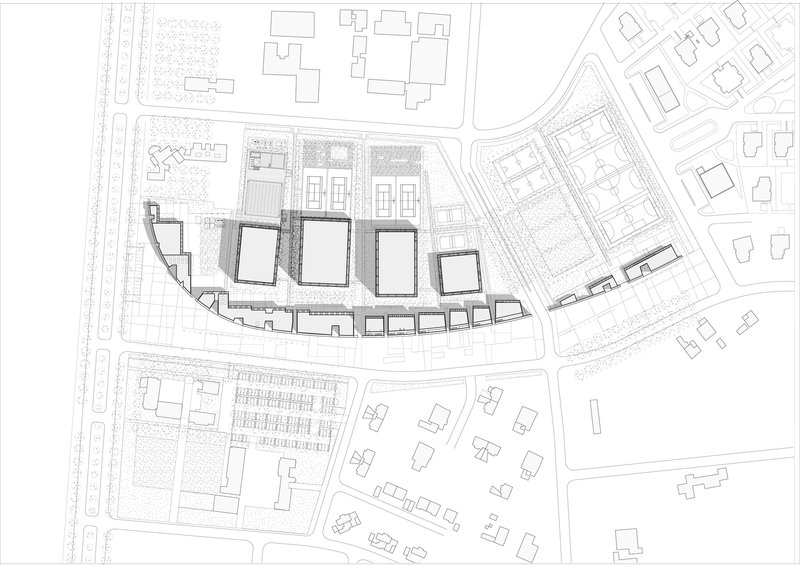 Site plan drawing showing four rectangular building volumes arranged along a curved plot boundary