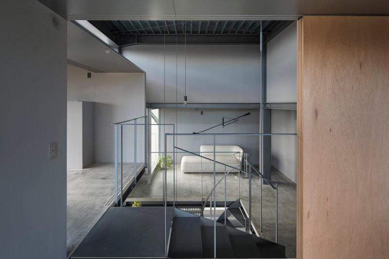 View across the upper floor with steel handrails and exposed ceiling joists in diffused daylight