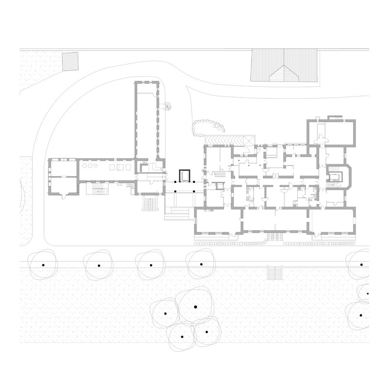 Ground floor plan drawing showing multiple wings connecting around a central courtyard with trees