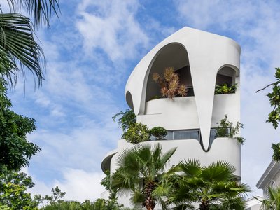 23o5Studio Wraps a Six-Bedroom Ho Chi Minh City Home in Curving White Terraces and Tropical Greenery
