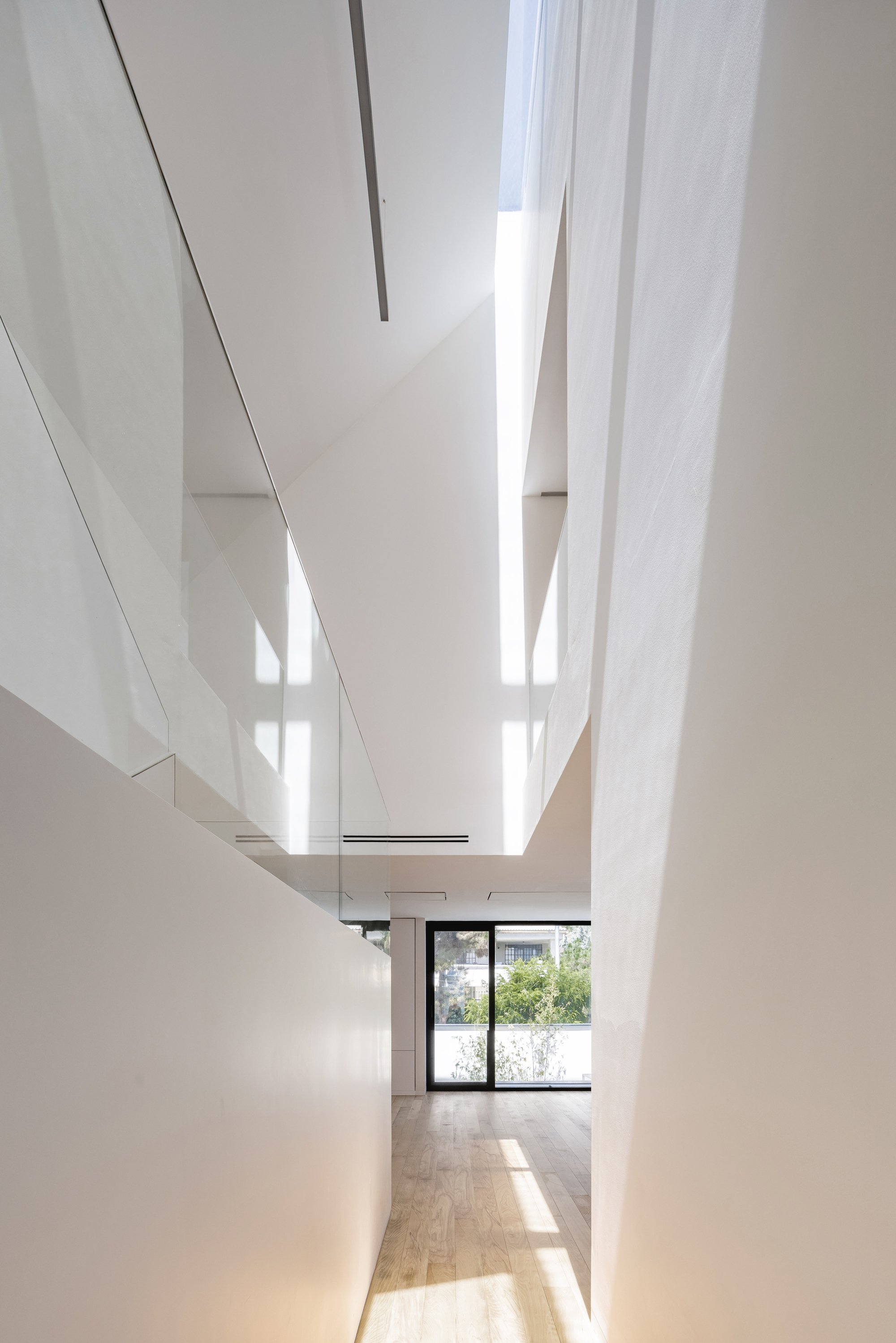 Next Office Folds a Tehran Villa into Itself, Turning Pitched Roofs into Vertical Light Wells