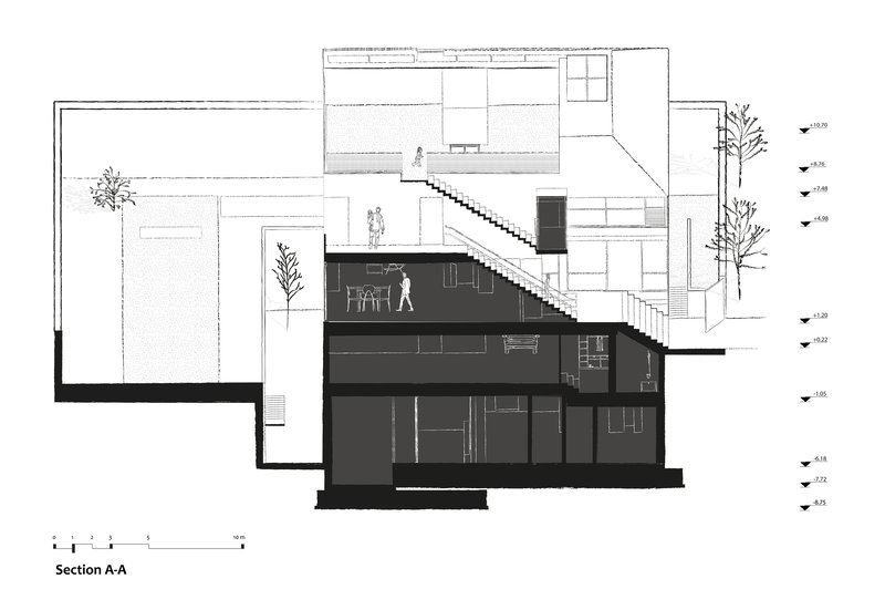 Section drawing illustrating split-level arrangement with diagonal staircase connecting ground and upper floors