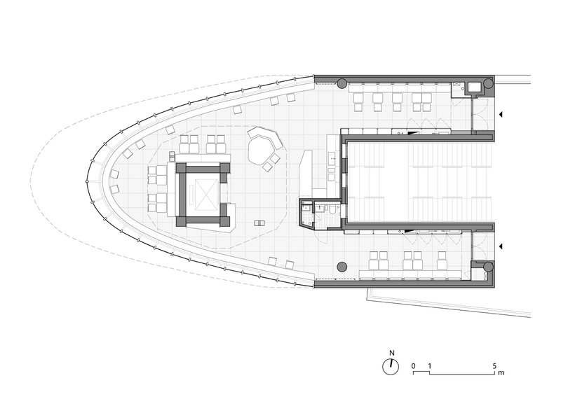 Floor plan showing a curving dining area with central service core and seating along the perimeter