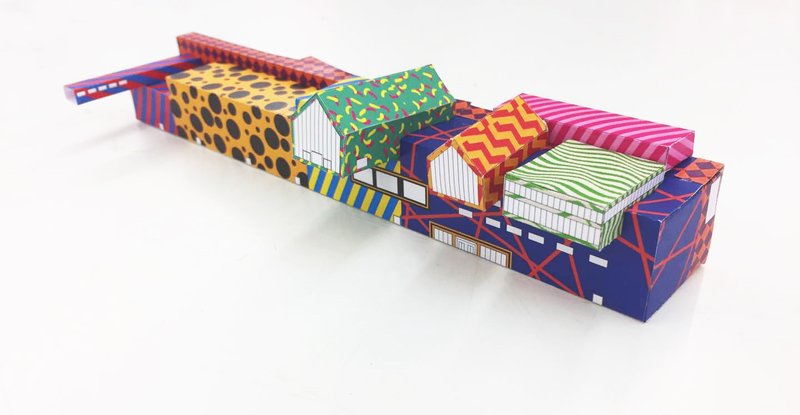 Architectural model with boldly patterned facades in zigzags, stripes, dots and geometric motifs