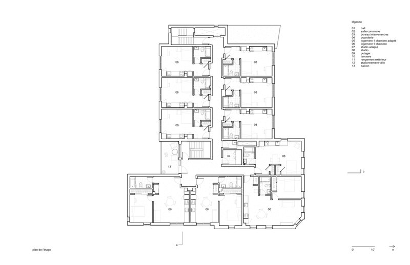 Upper floor plan drawing showing residential units with private bathrooms and shared circulation spaces