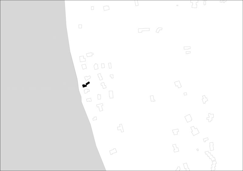 Site plan drawing showing a cluster of scattered building footprints with one highlighted in black