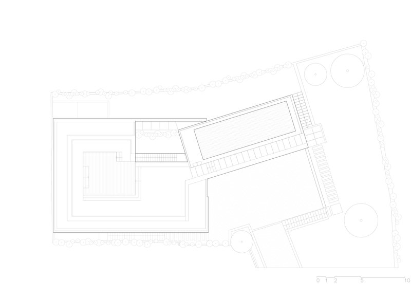 Roof plan drawing showing angled volumes with deck areas and circular tree plantings