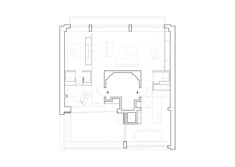 Floor plan drawing showing rectangular perimeter with central void and distributed living spaces