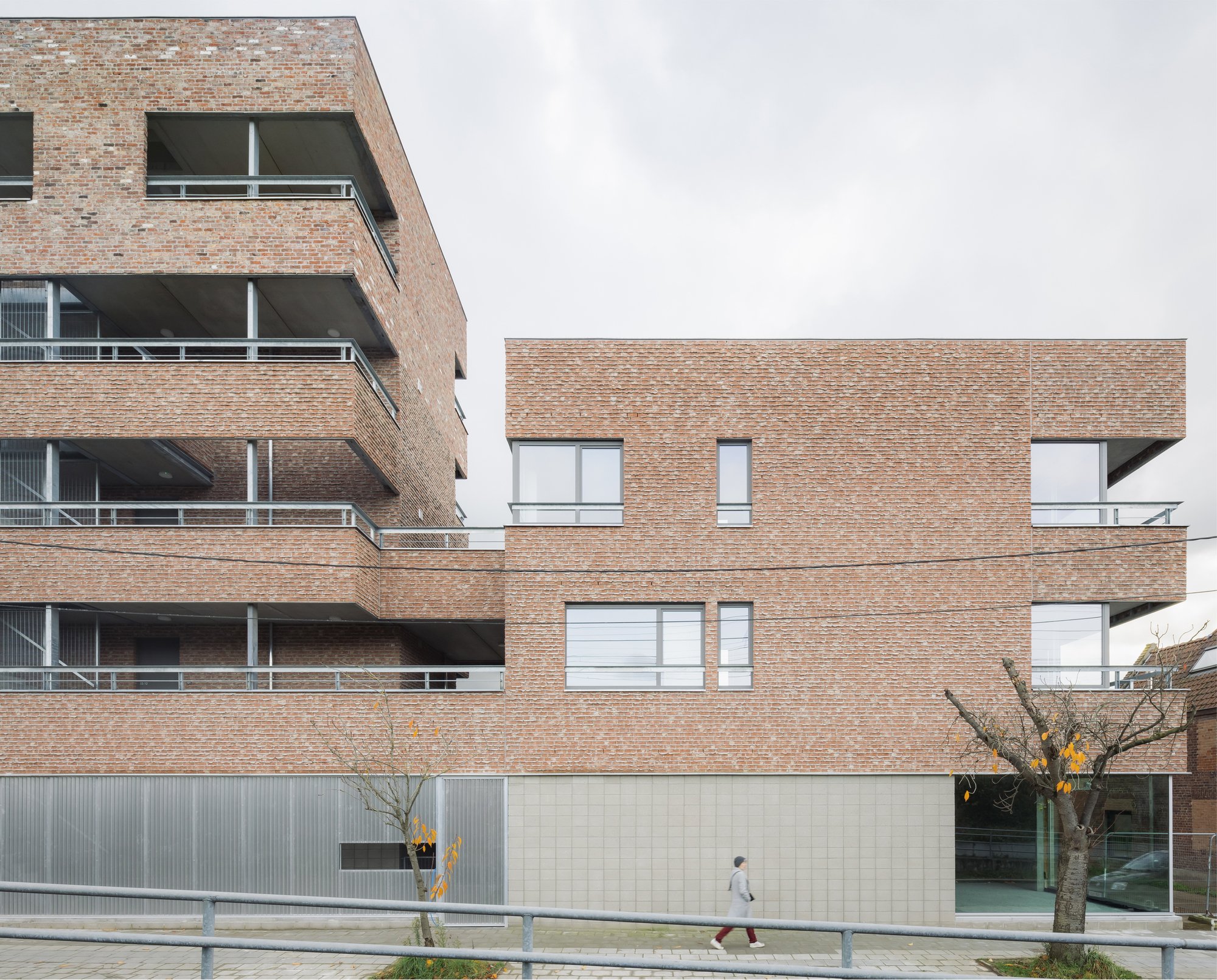 MAKER Architecten Weaves Social Housing into Kortrijk's Dense Urban Fabric with Brick and Restraint
