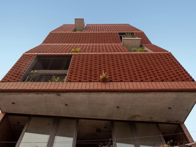 H&P Architects Stack a Vertical River of Brick and Greenery in Hanoi