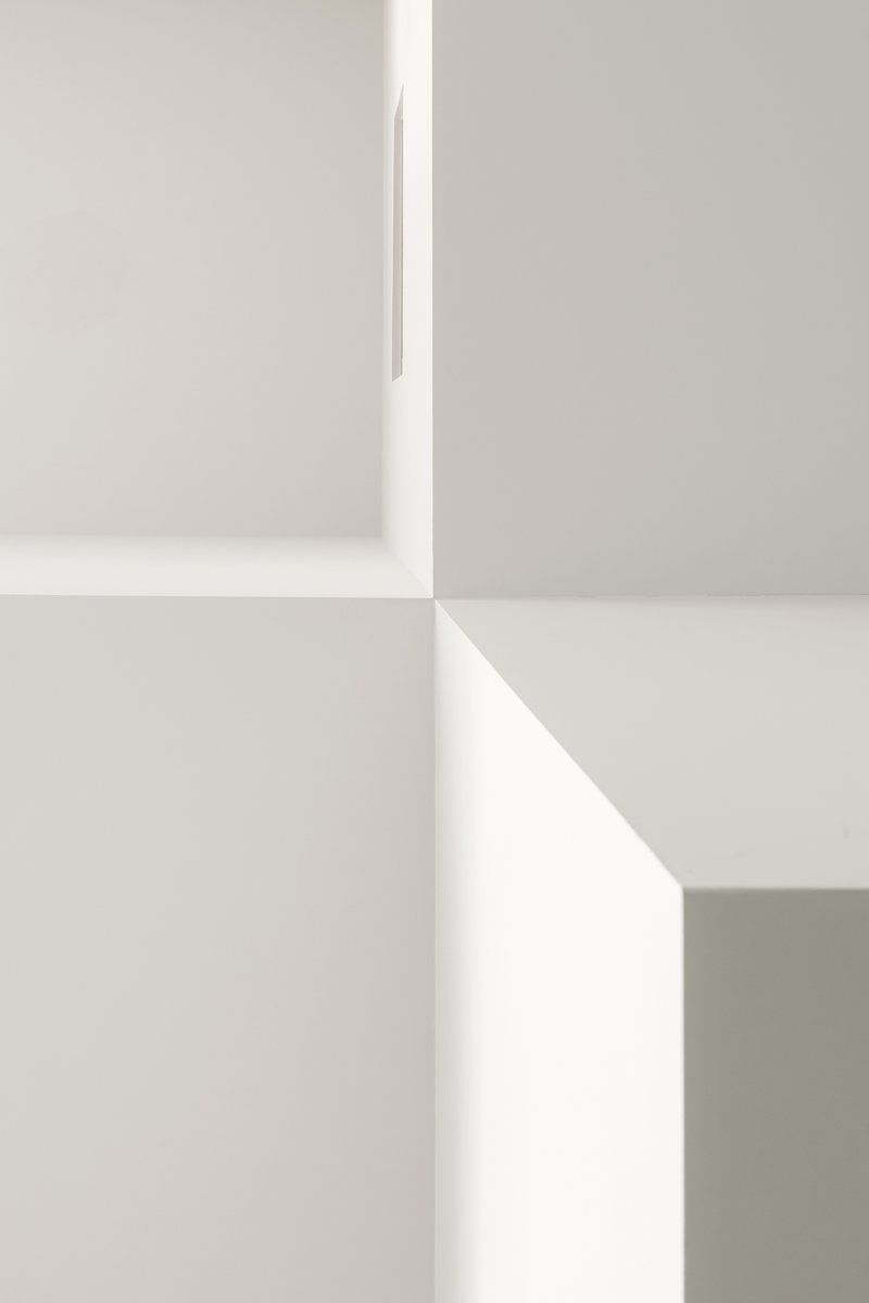 Close-up of white wall corners meeting at sharp angles under diffused natural light