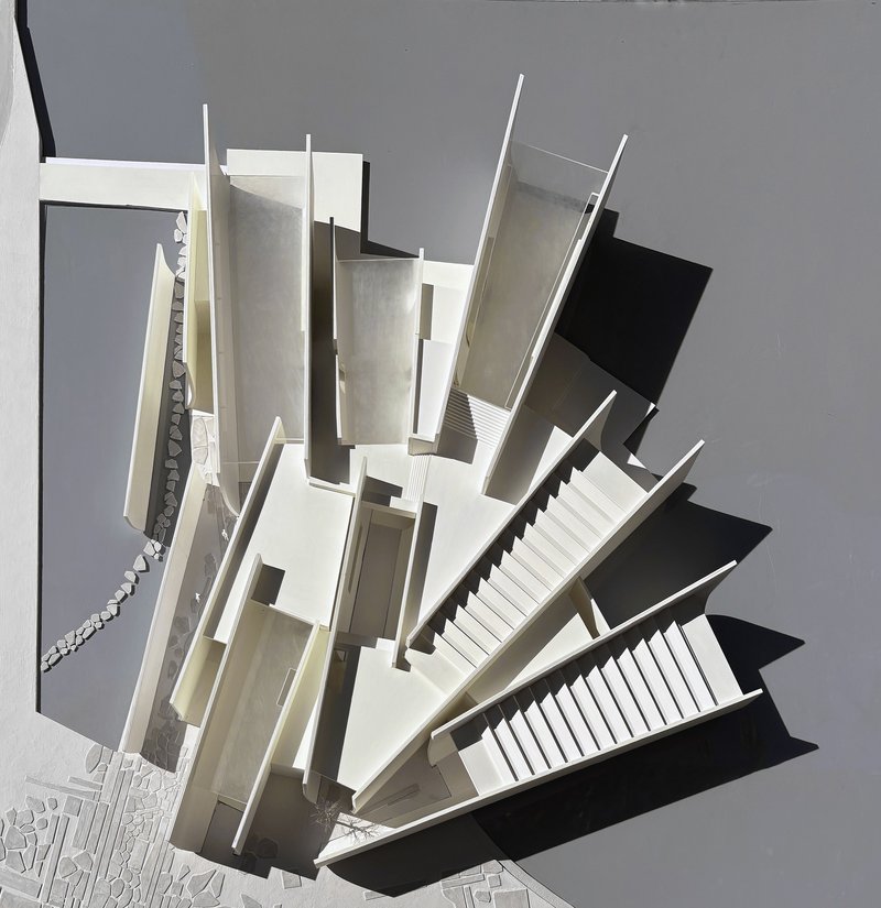Axonometric sectional model exposing vertical circulation, staircases, and spatial layering between floor plates