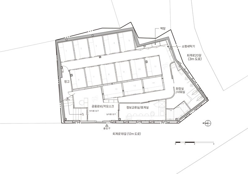Floor plan drawing showing an angled perimeter with central corridor and cellular rooms