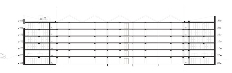 Floor plan drawing showing a long rectangular layout with central circulation core and stairwells at each end