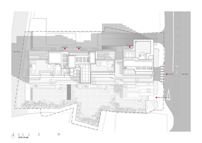 Site plan drawing showing the building footprint surrounded by landscaped areas and adjacent roads