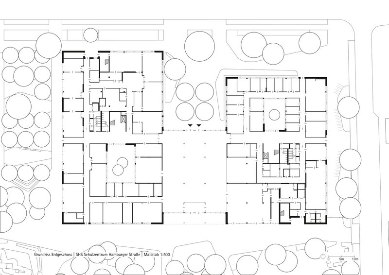 Ground floor plan drawing showing four building volumes arranged around a central courtyard with trees