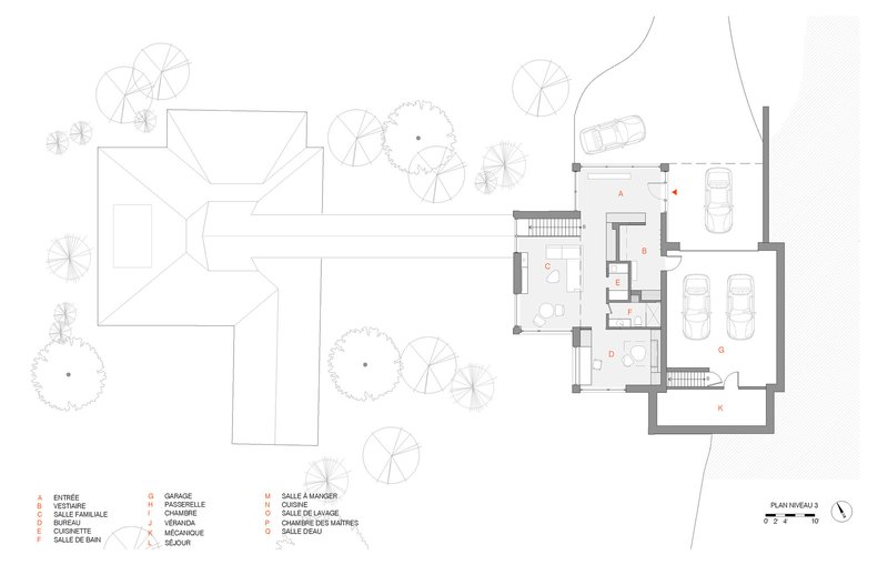 Site plan drawing showing an existing house with trees and a new garage addition with cars