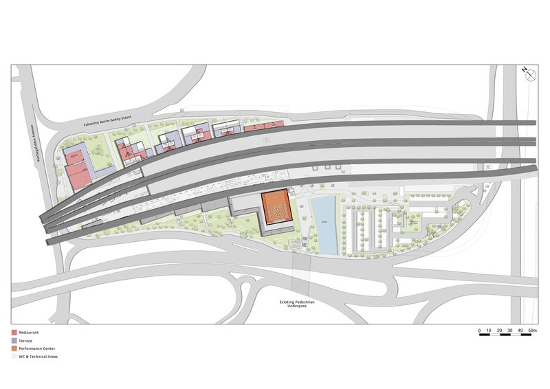 Master plan drawing showing curved railway tracks crossing through a development zone with colored program blocks and green spaces