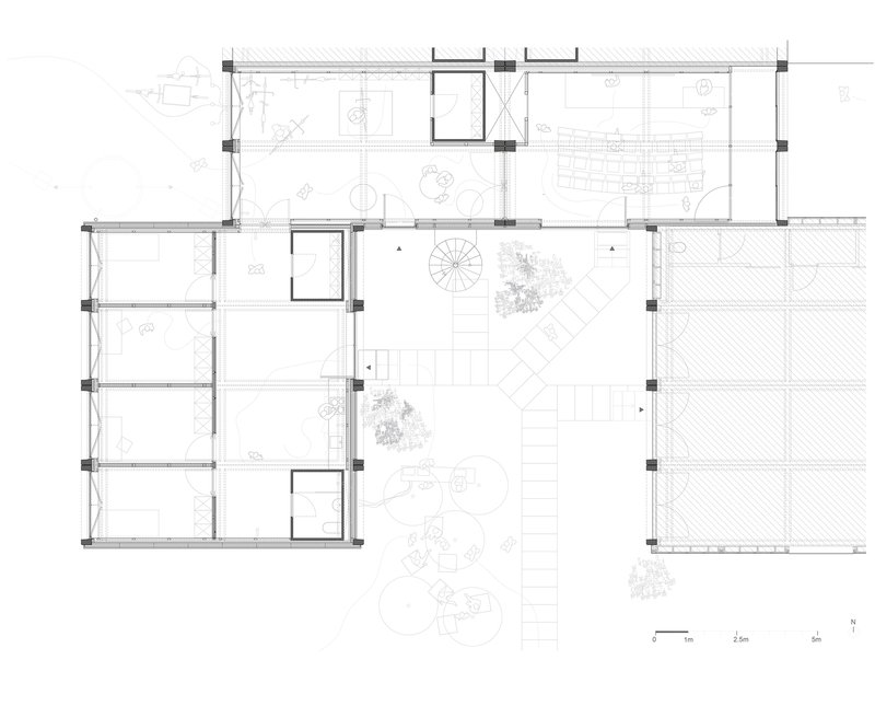 Floor plan drawing showing L-shaped layout with central spiral stair and surrounding courtyard plantings