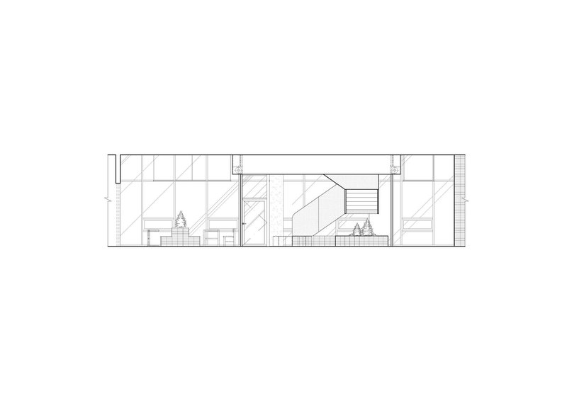 Section drawing revealing multi-level interior with central staircase and glazed facade panels