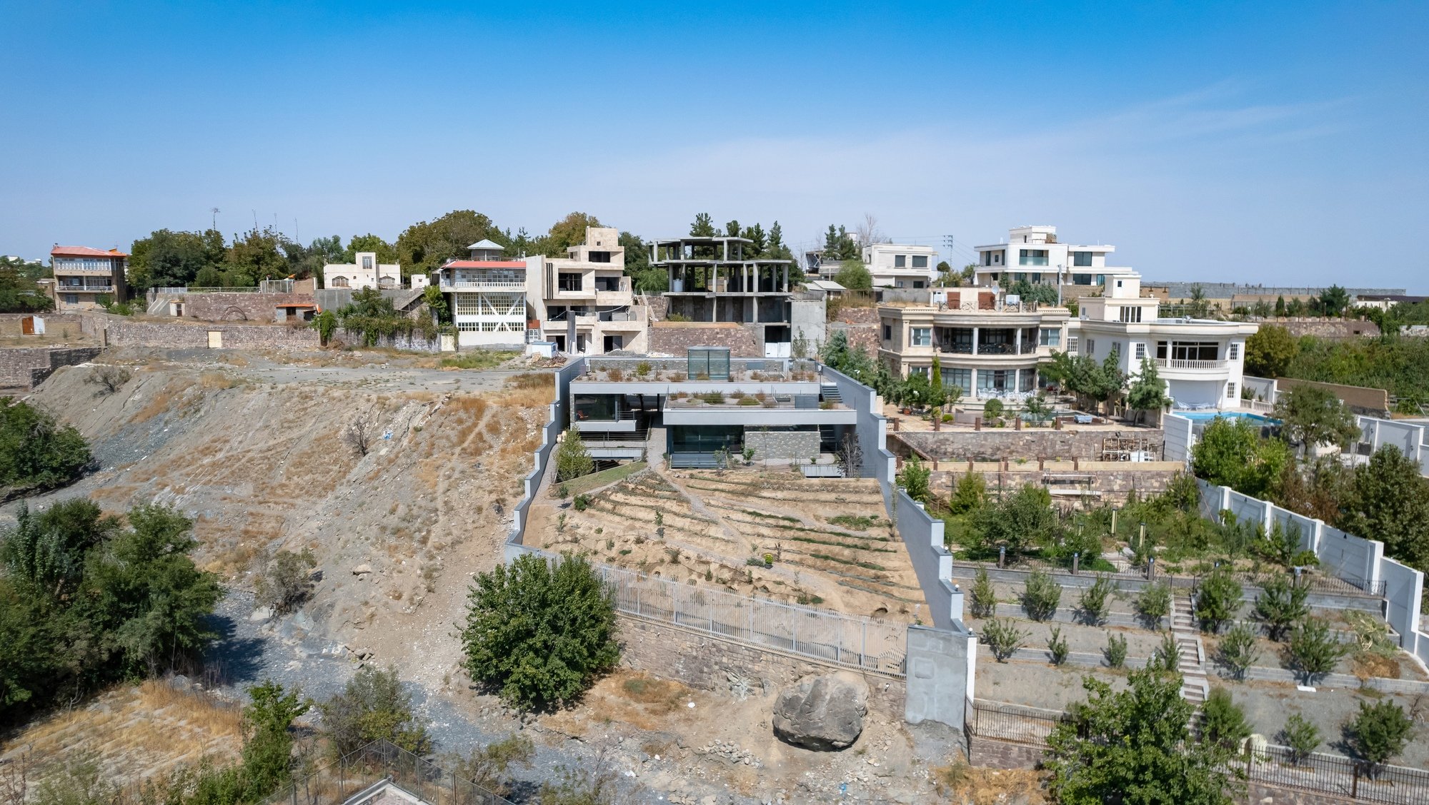 ABAR Office Carves a Weekend Villa into a Steep Hillside Adjacent to a Seasonal River in Shandiz