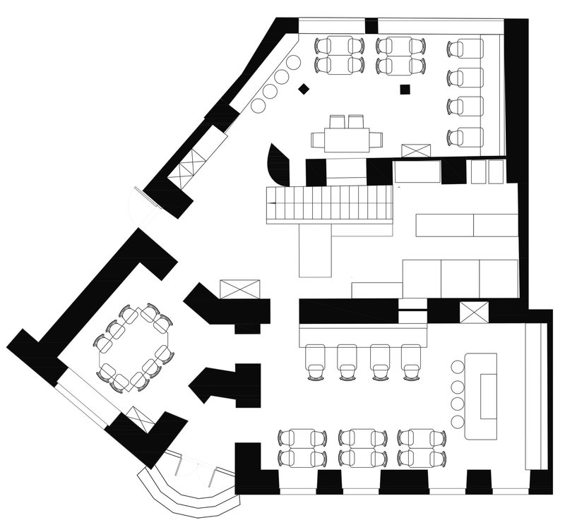 Floor plan drawing showing dining areas with booth and table seating arranged around a central staircase