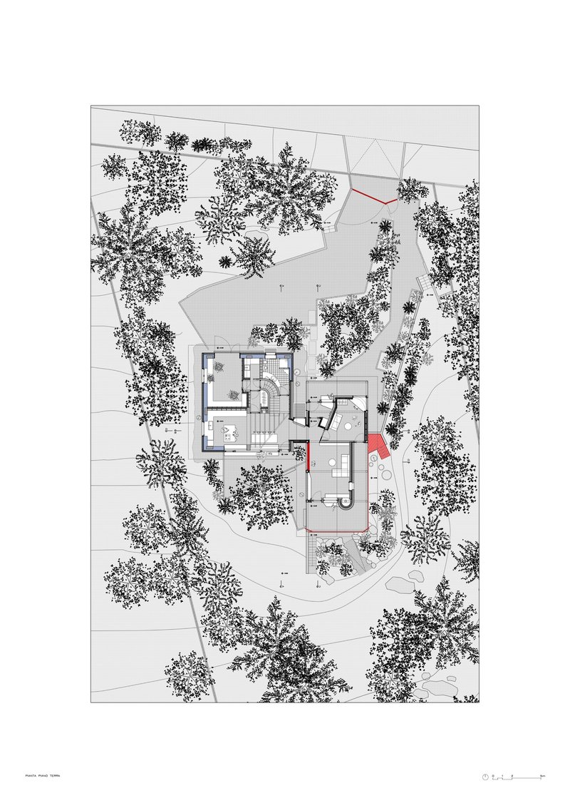 Site plan drawing depicting residential structure with red accent elements amid dense tree coverage