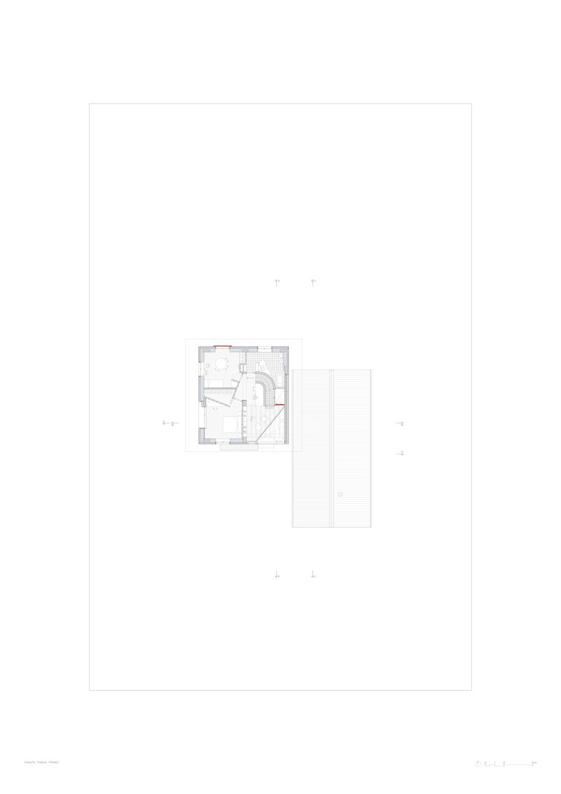 Floor plan drawing showing two rectangular volumes with curved interior staircase and room divisions