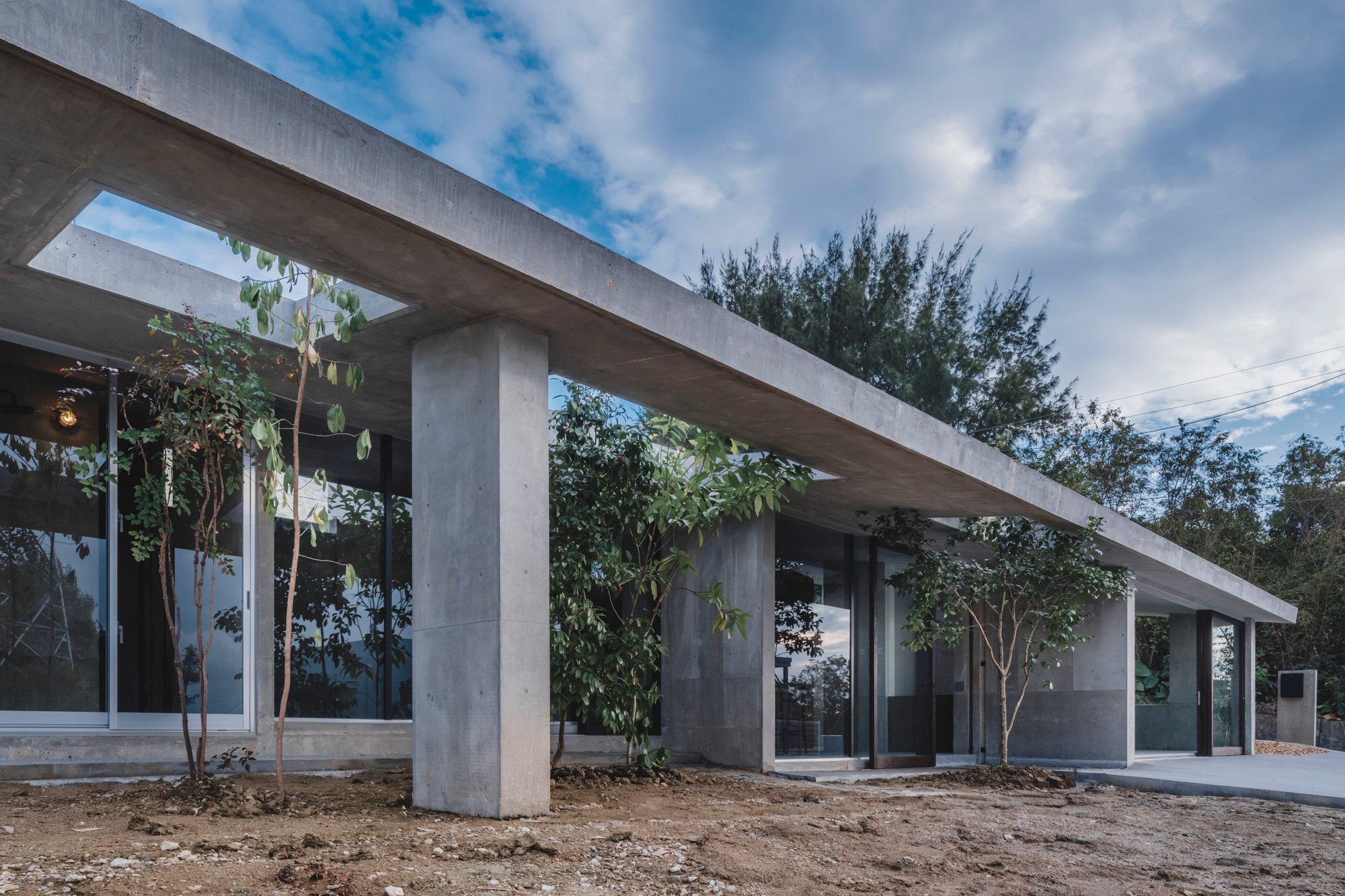 IGArchitects Plants Trees Through a Concrete Canopy for a Post-Parenthood Home in Okinawa