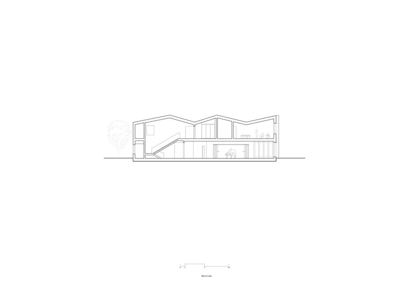 Section drawing showing interior staircase and zigzag roofline with adjacent tree outline